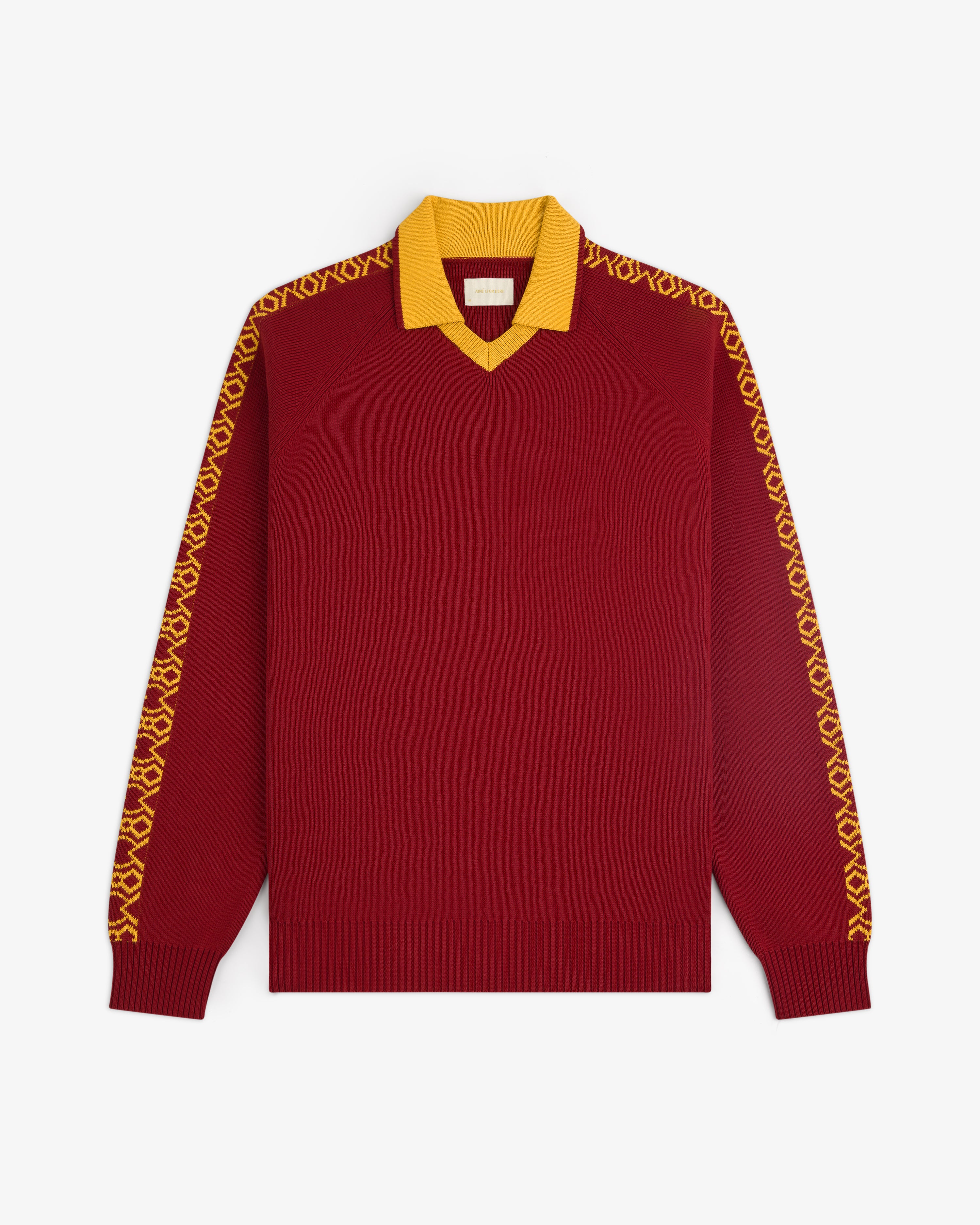 The Knit Sport Pullover is a red long-sleeve sweater with a yellow collar and patterned yellow sleeve designs.