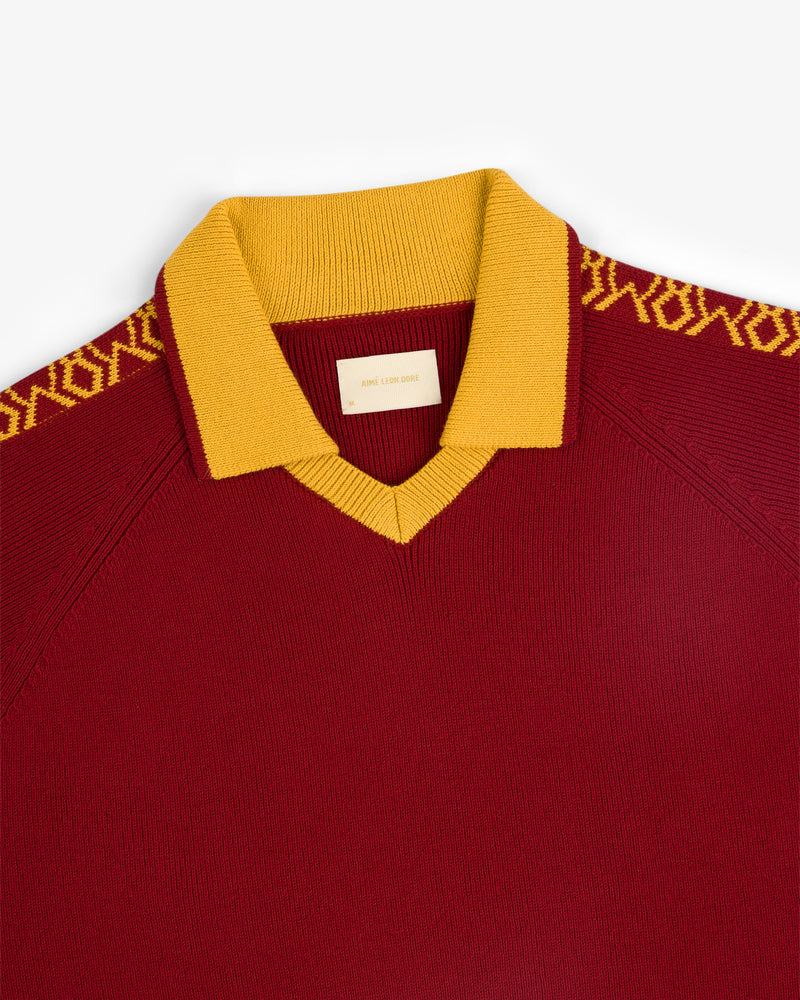 Knit Sport Pullover in maroon with yellow collar and geometric shoulder patterns.