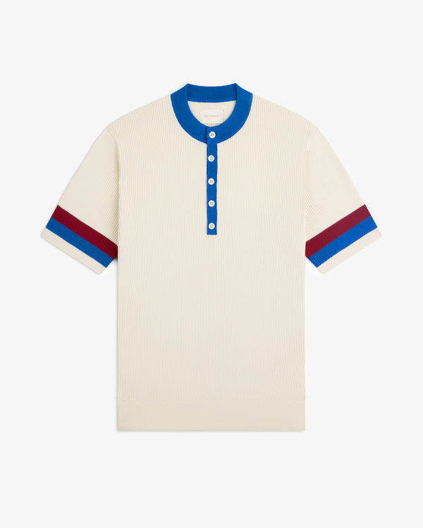 Sport Knit Henley: Cream short-sleeve knit shirt with blue collar, blue buttons, and red/blue sleeve stripes.