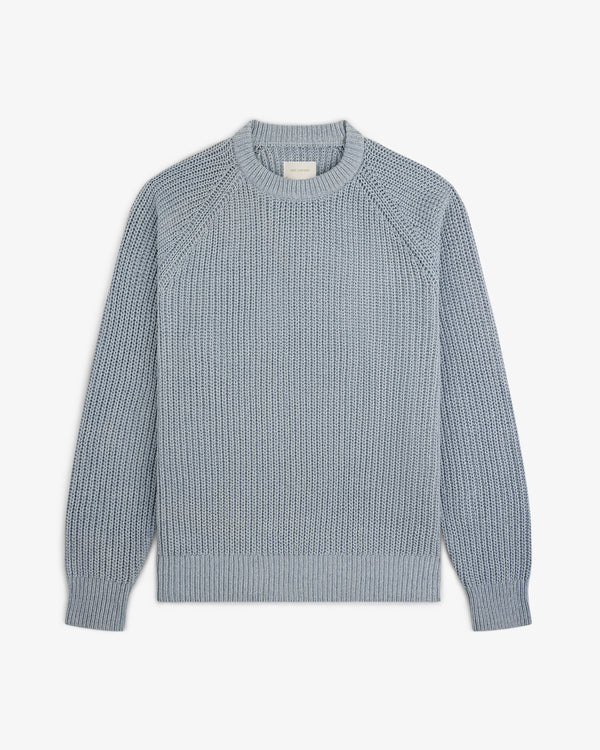 Light blue Knit Denim Crewneck Sweater with ribbed cuffs, collar, and hem shown on a white background.