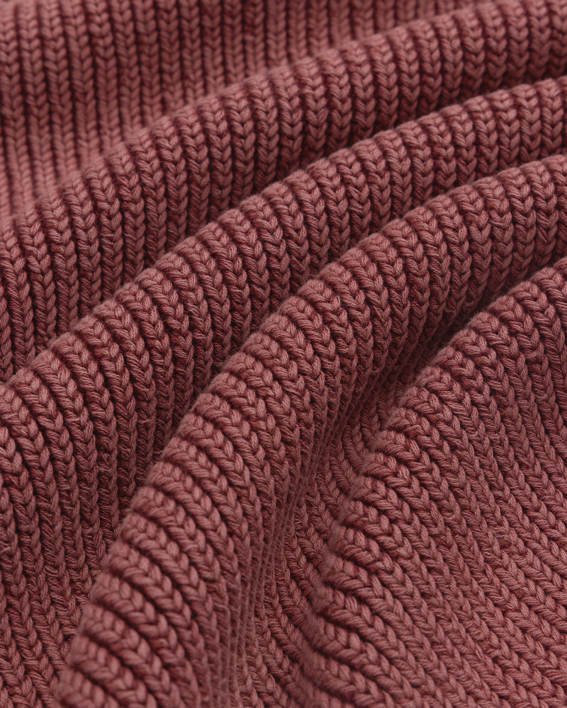Close-up of the textured ribbed fabric and wavy folds on the maroon Stone Washed Knit Polo.