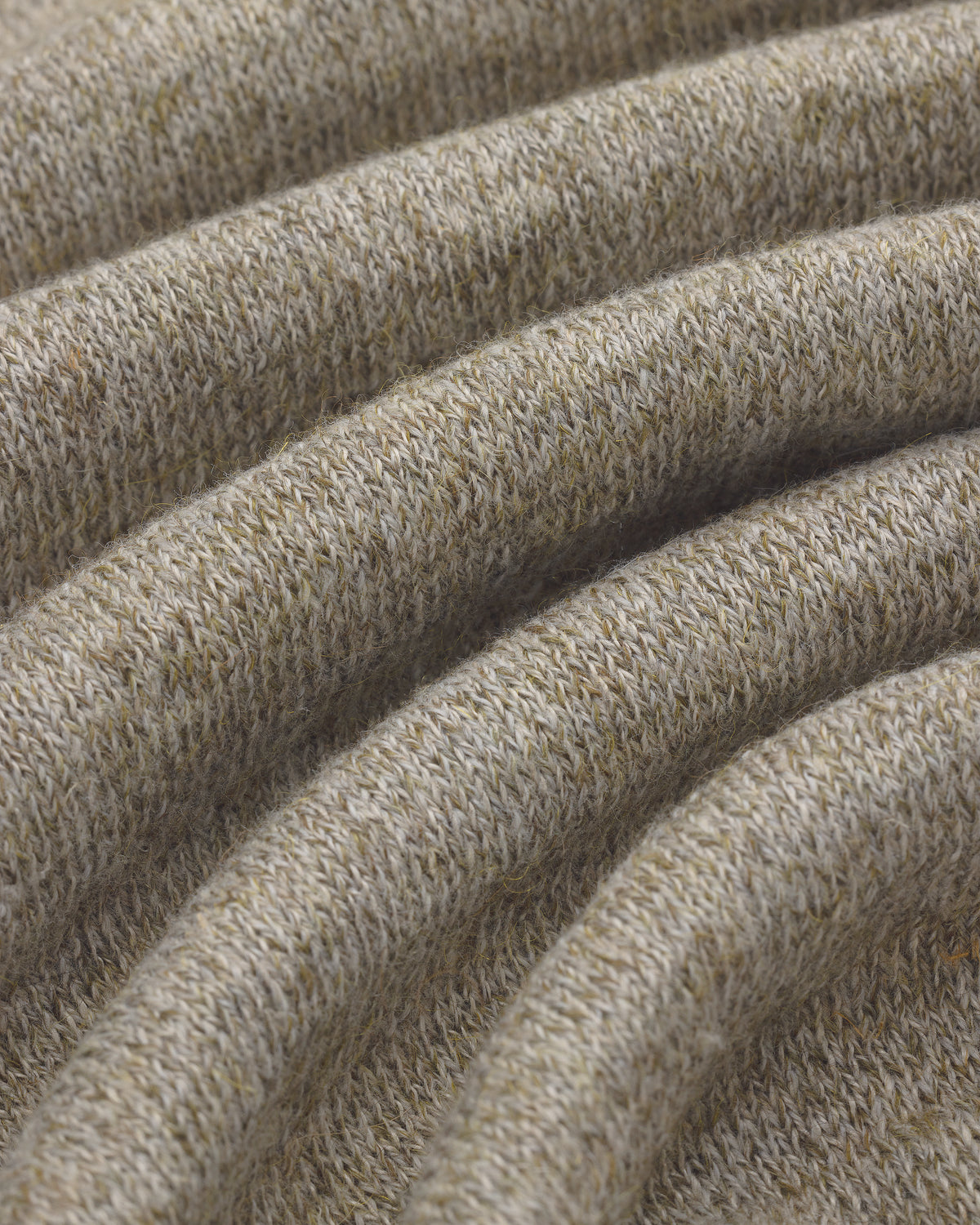 Close-up of the Long-Sleeve Knit Pocket Tee in light beige, showing textured knit fabric with visible stitches.