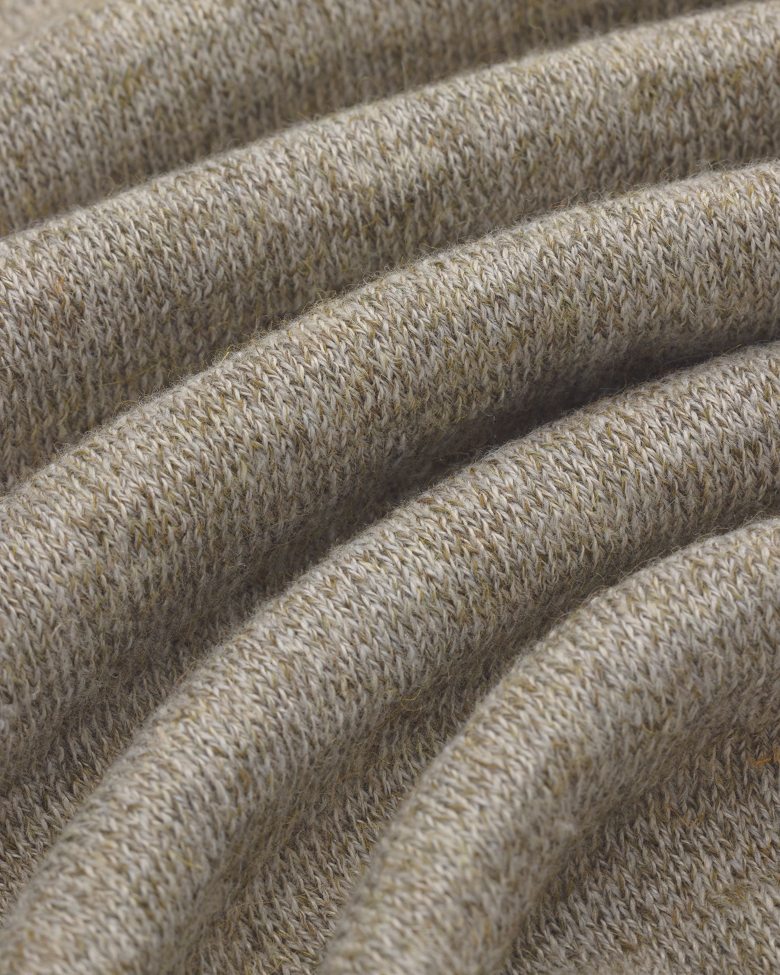 Close-up of the Long-Sleeve Knit Pocket Tee in light beige, showing textured knit fabric with visible stitches.