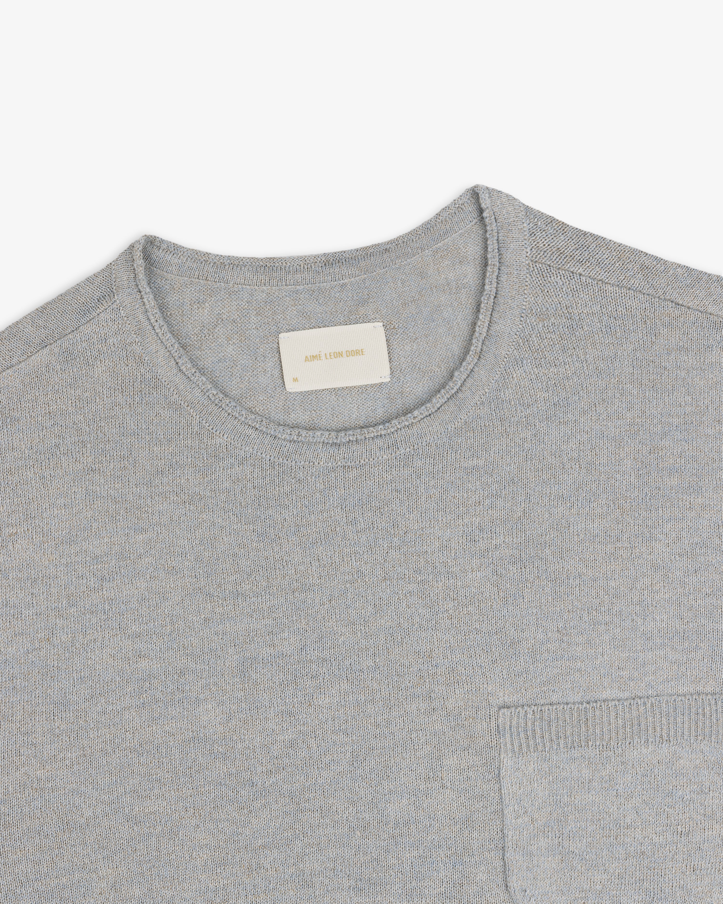 Light gray Long-Sleeve Knit Pocket Tee with chest pocket, shown from above to highlight the neckline and label.