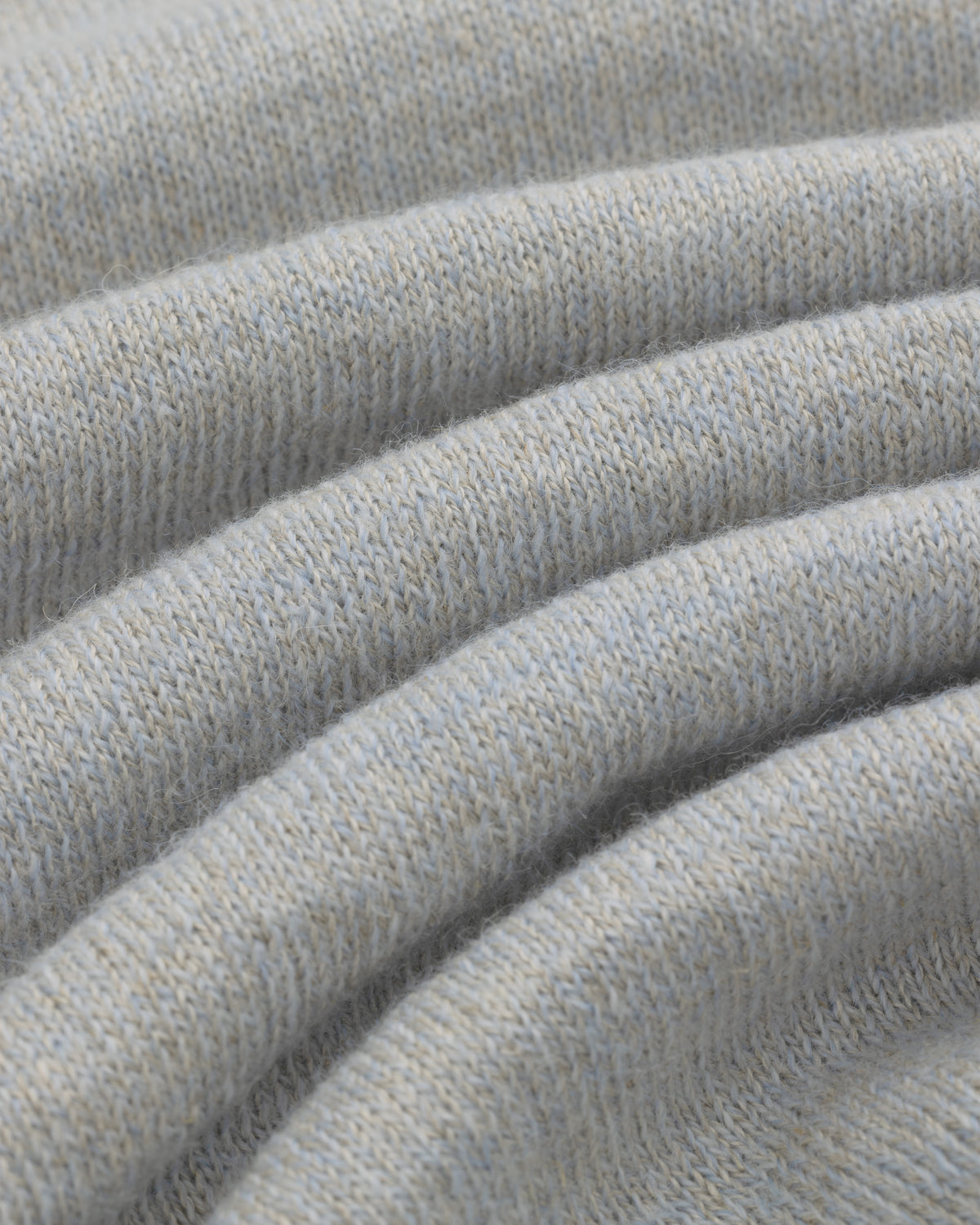 Close-up of light gray Long-Sleeve Knit Pocket Tee, showing its soft folds and textured knit pattern.