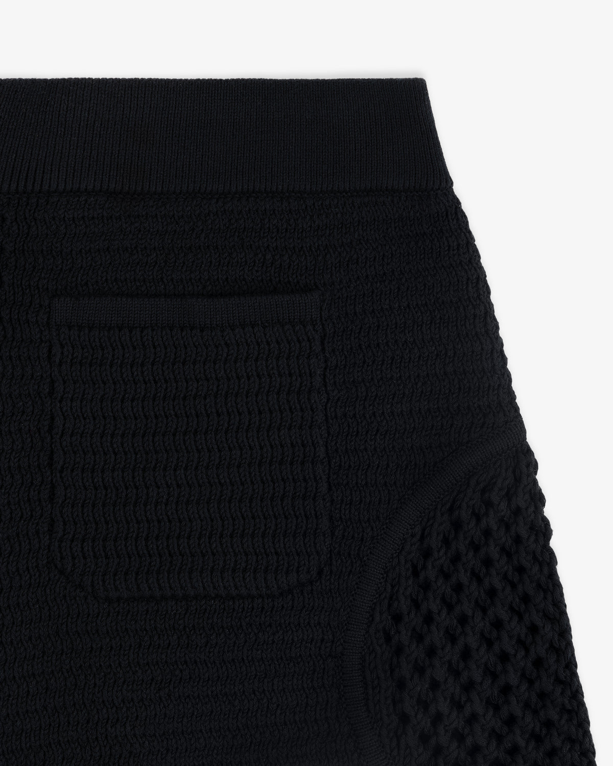 Close-up of the Knit Court Short in black, featuring textured knit, ribbed waistband, and small front pocket.