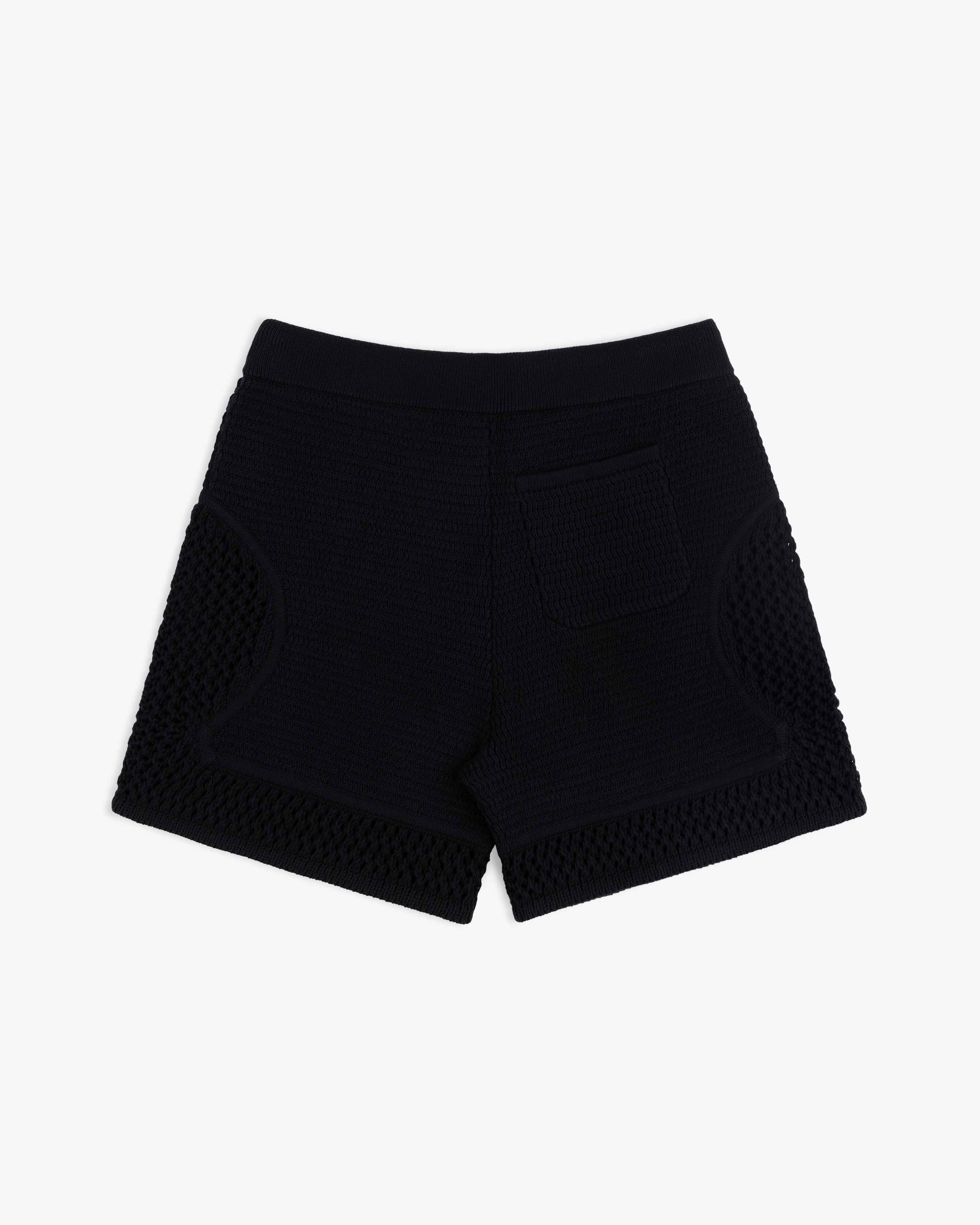 Knit Court Short in black textured knit with back pocket, shown from behind on a plain white background.