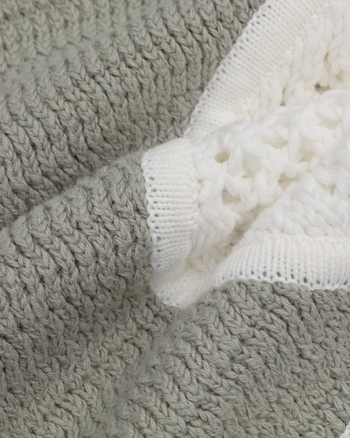 Close-up of Knit Court Short fabric, featuring textured gray and white knit for a soft, cozy feel.