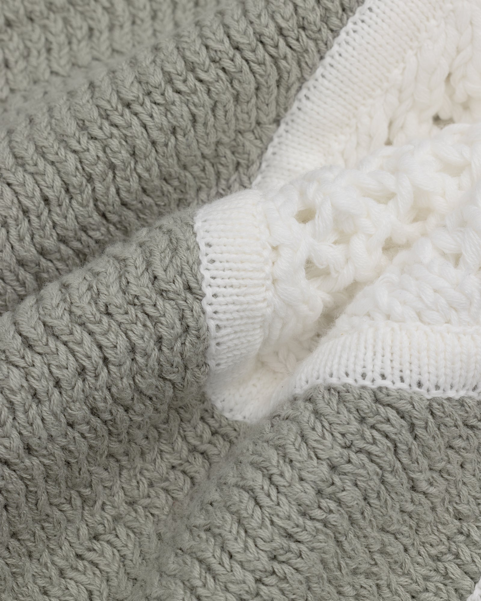 Close-up of Knit Court Short fabric, featuring textured gray and white knit for a soft, cozy feel.