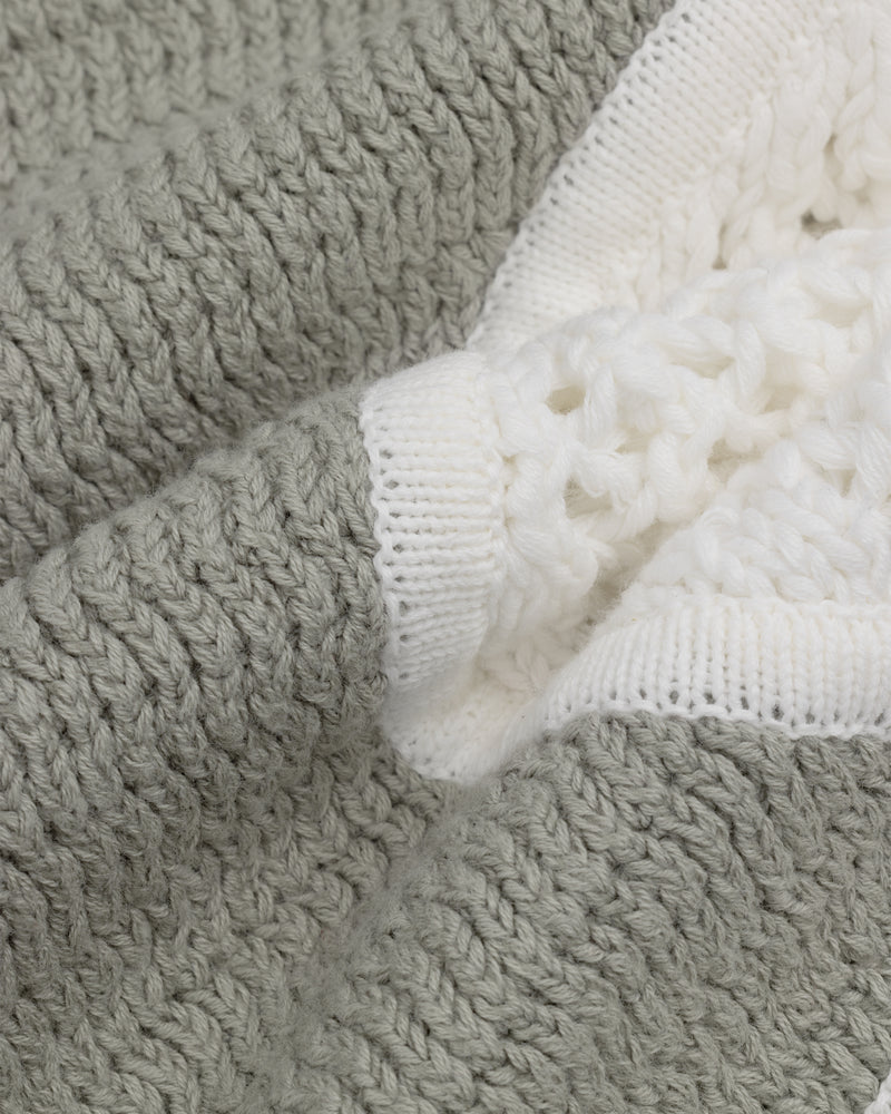 Close-up of Knit Court Short fabric, featuring textured gray and white knit for a soft, cozy feel.