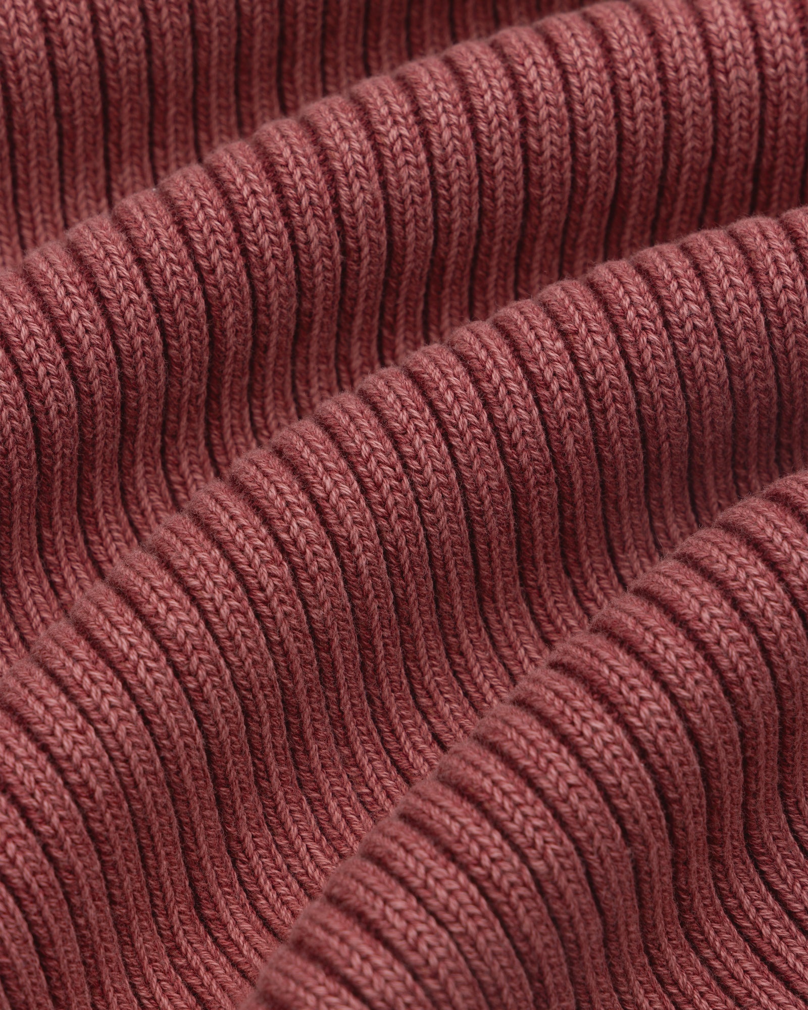 Close-up of ribbed, reddish-brown Stone Washed Knit Tank Top fabric with repeating raised and recessed textures.
