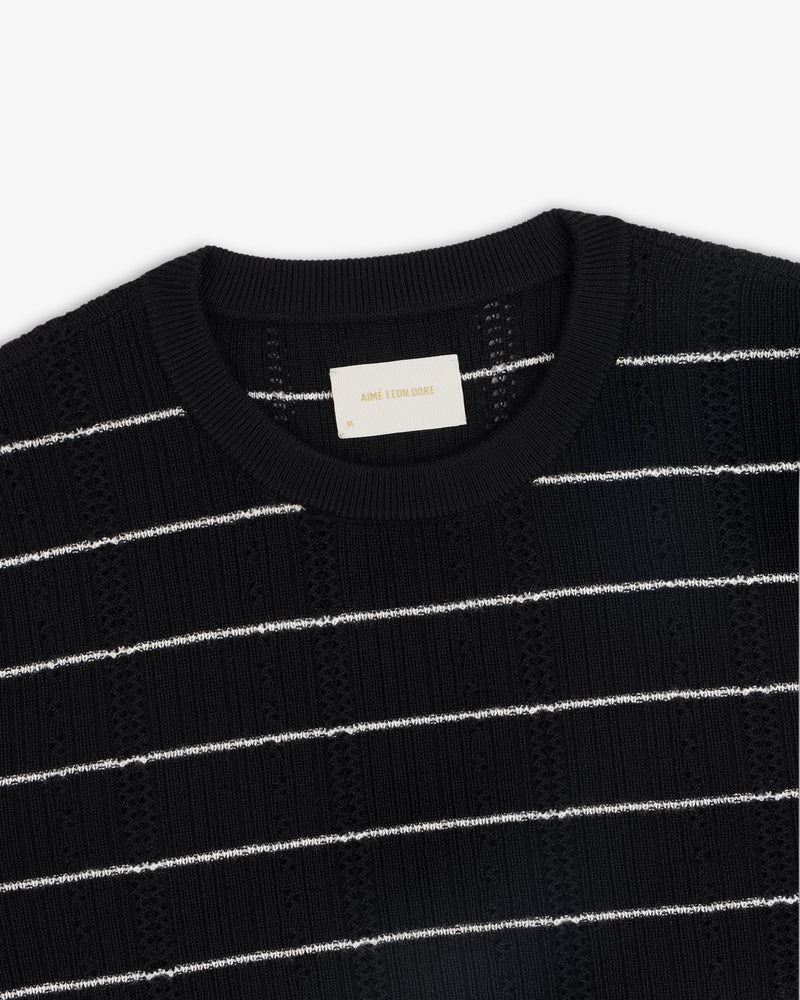 Merino Wool Eyelet Tee in black with white horizontal stripes and a visible white collar label.