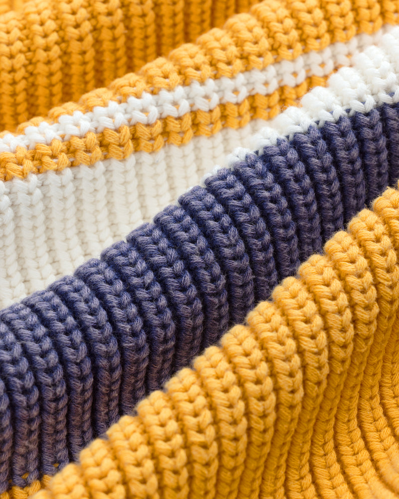 Close-up of Striped Knit Rugby fabric with horizontal stripes in yellow, white, and dark blue.