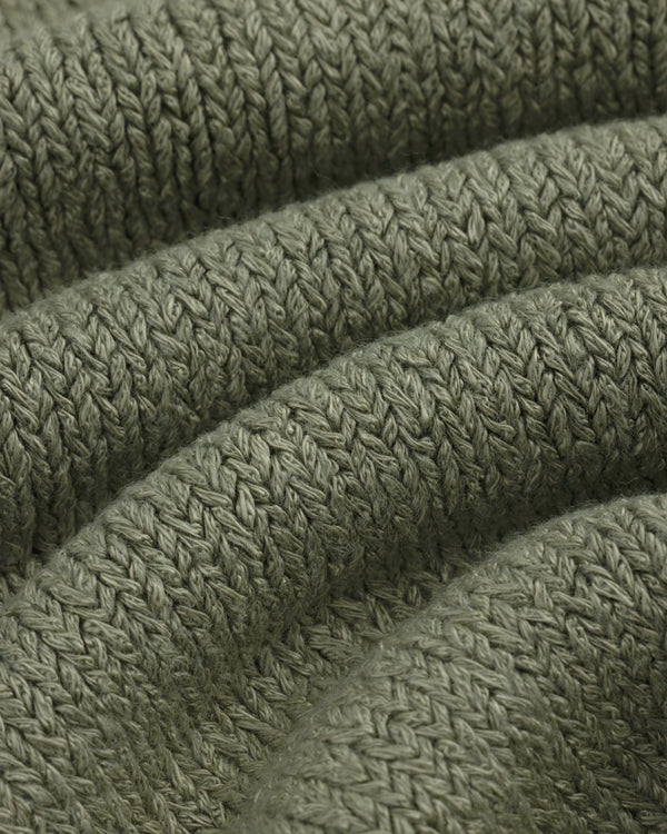 Close-up of olive green Linen Knit Drawstring Short showing textured, curved rows of stitches.
