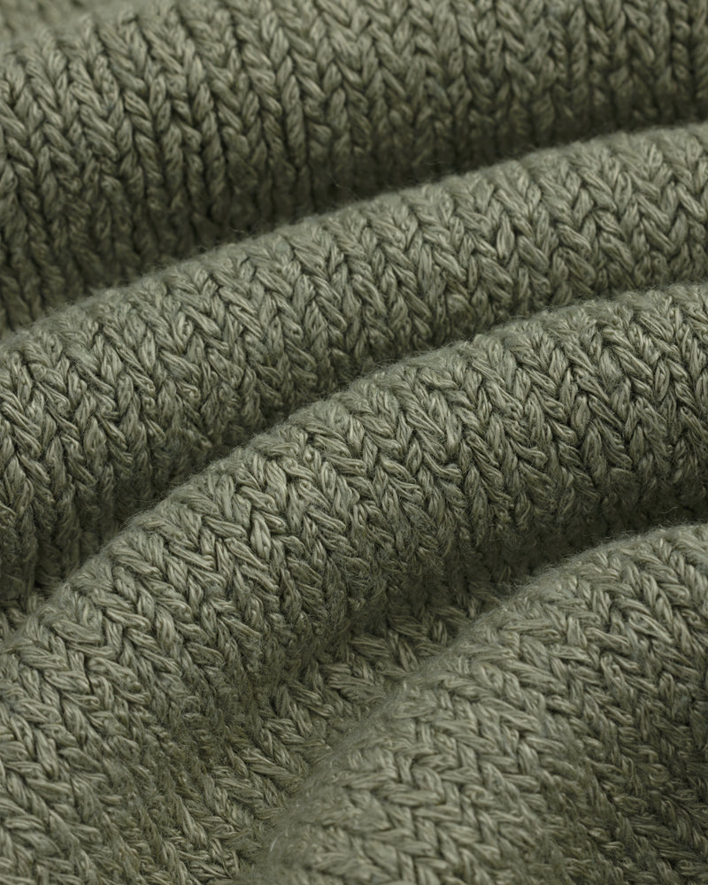 Close-up of olive green Linen Knit Drawstring Short showing textured, curved rows of stitches.