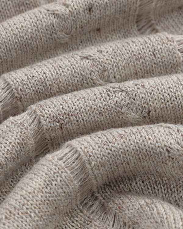 Close-up of the Pointelle Tank Top's textured beige knit fabric with visible fibers and a soft, cozy look.
