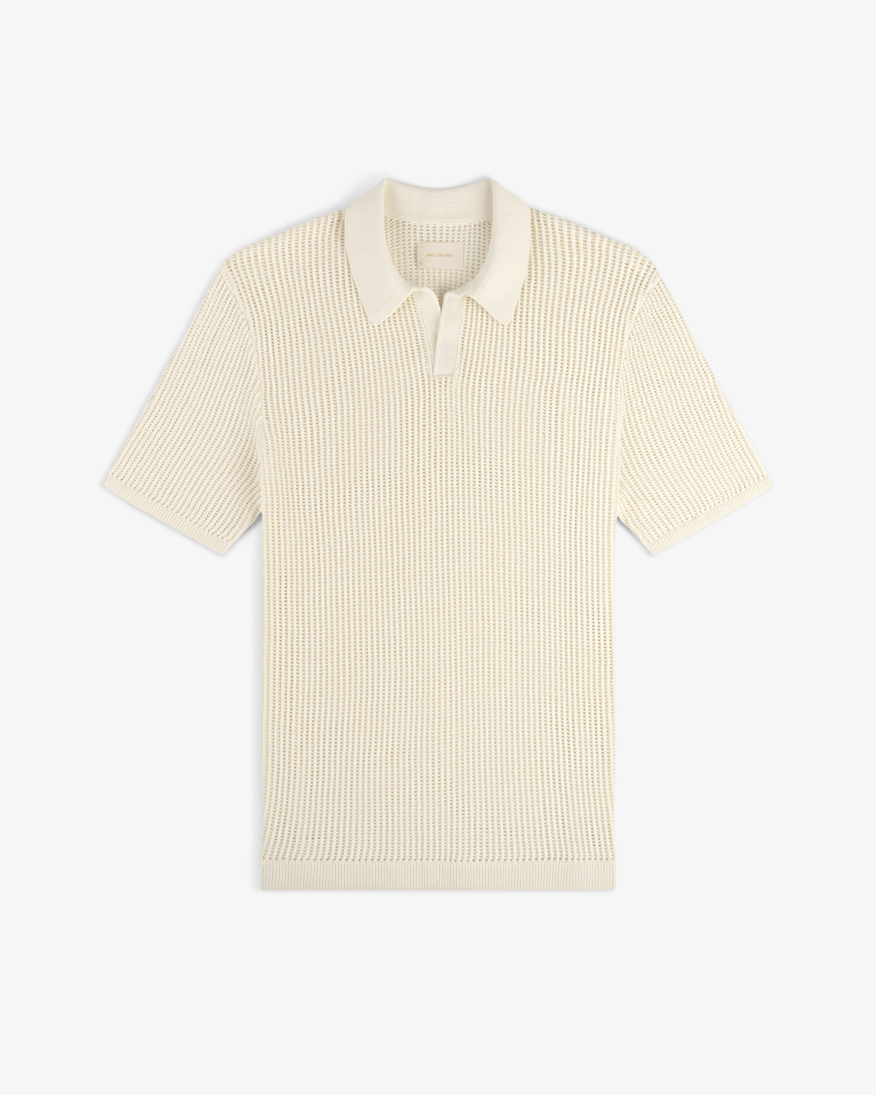 Cream-colored Mesh Knit Polo with short sleeves, ribbed texture, and classic collar laid flat on a white background.