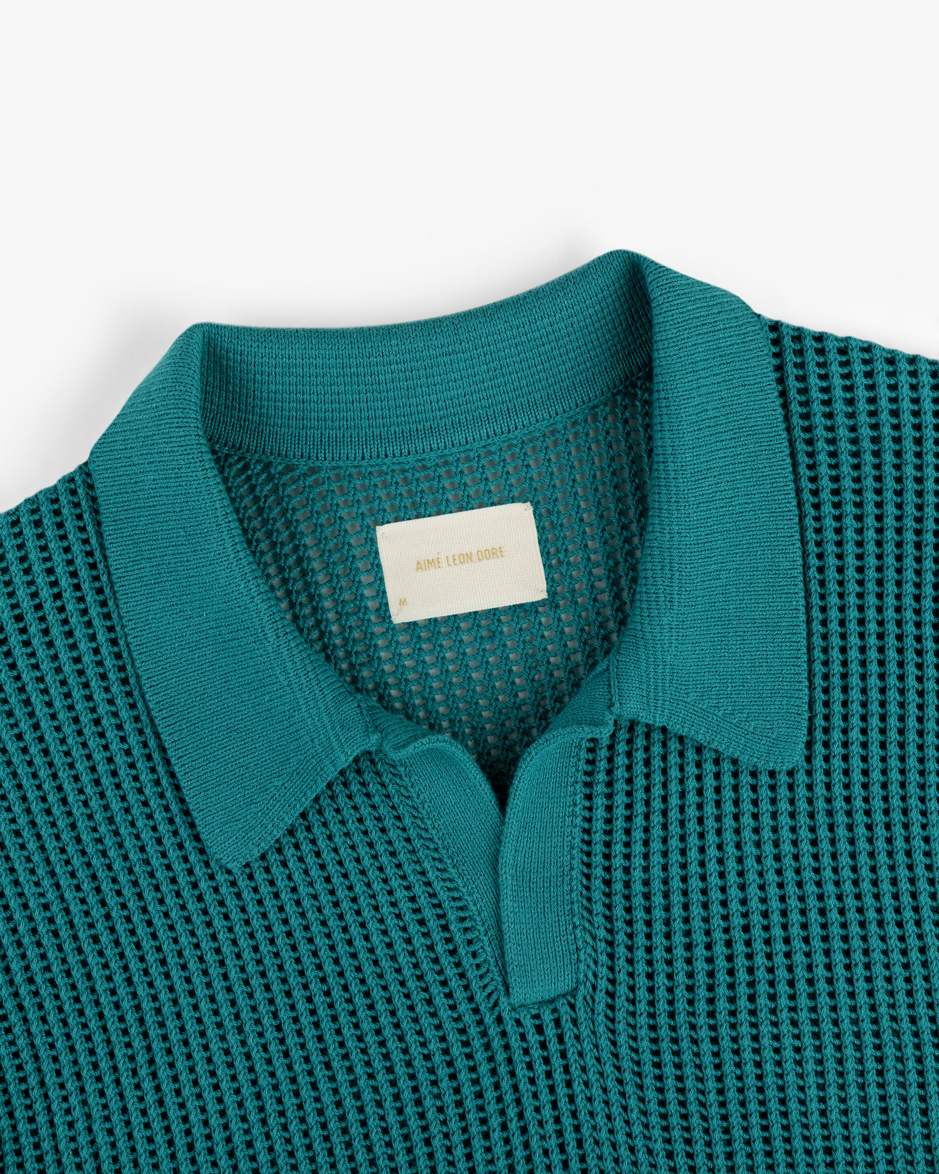 Teal Mesh Knit Polo with a textured pattern and a beige label inside the neckline.