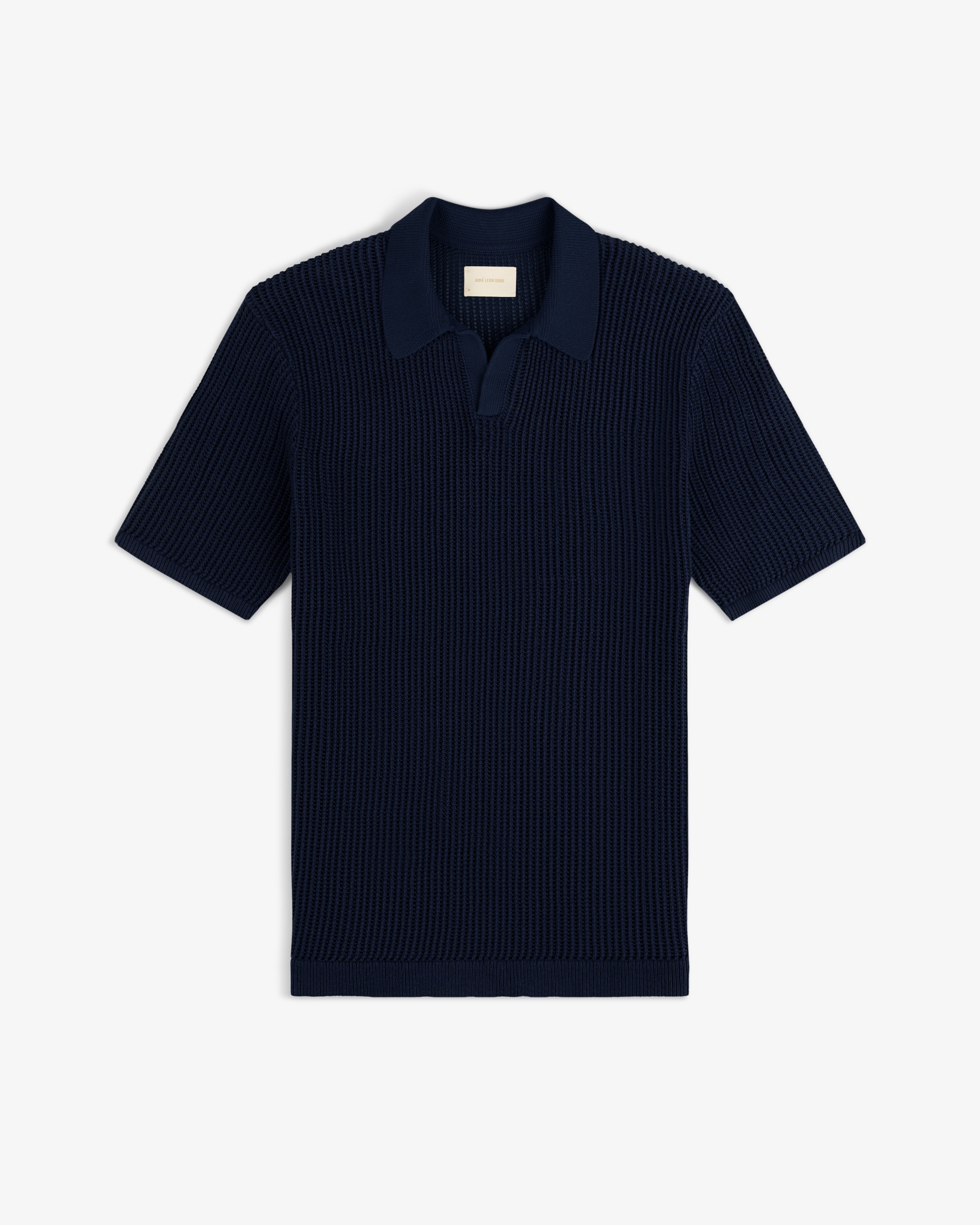 Mesh Knit Polo in navy blue with short sleeves, ribbed texture, and open collar, laid flat on white background.