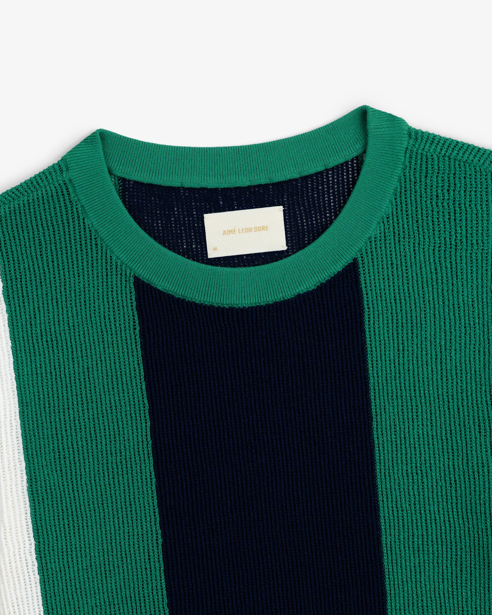 Striped Mesh Knit Tee in green with vertical navy and white stripes and a beige label inside the collar.