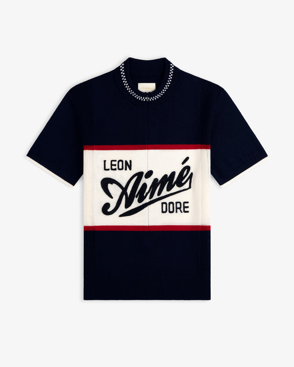 Navy Merino Wool Cycling Jersey with AIMÉ LEON DORE text in bold script, block letters, and red/white stripes.