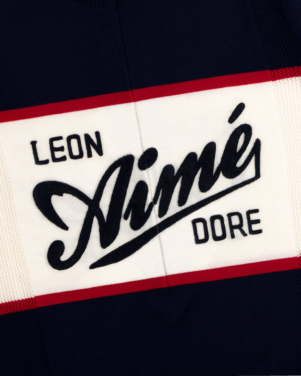 A navy, white, and red Merino Wool Cycling Jersey with Leon Aimé Dore written across the front.