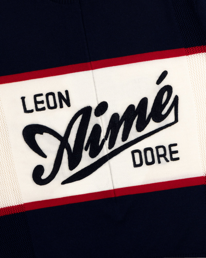 A navy, white, and red Merino Wool Cycling Jersey with Leon Aimé Dore written across the front.