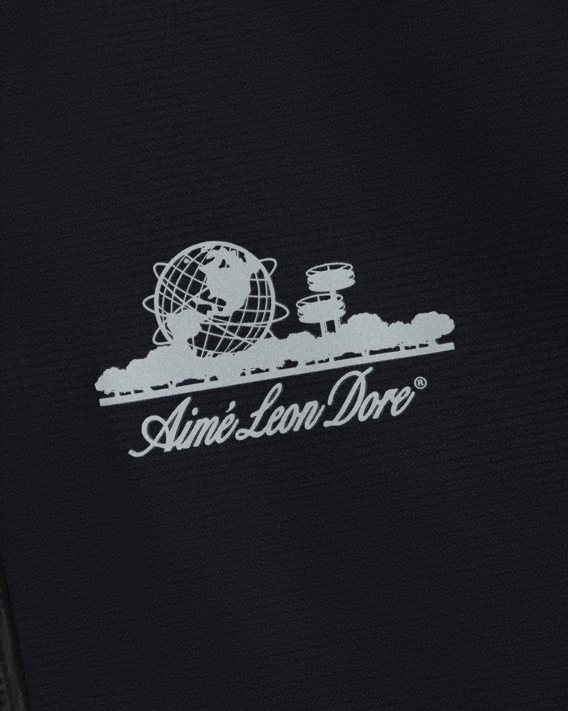 White Aimé Leon Dore logo with globe, trees, and observatory on the Lightweight GORE-TEX Shell Jacket.