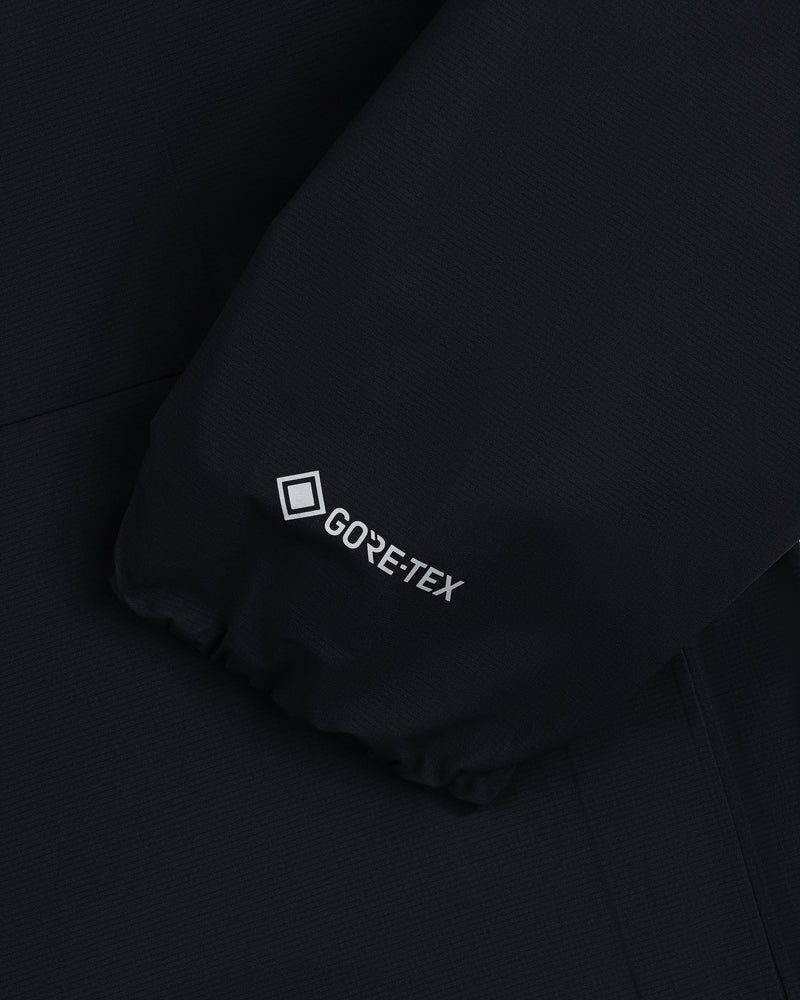 Close-up of Lightweight GORE-TEX Shell Jacket's black sleeve with white GORE-TEX logo near the cuff.
