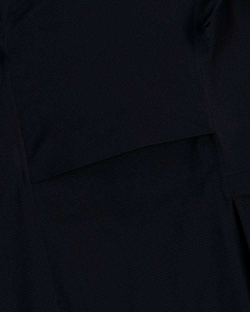 Close-up of black fabric with a seam on the Lightweight GORE-TEX Shell Jacket showing its subtle texture.
