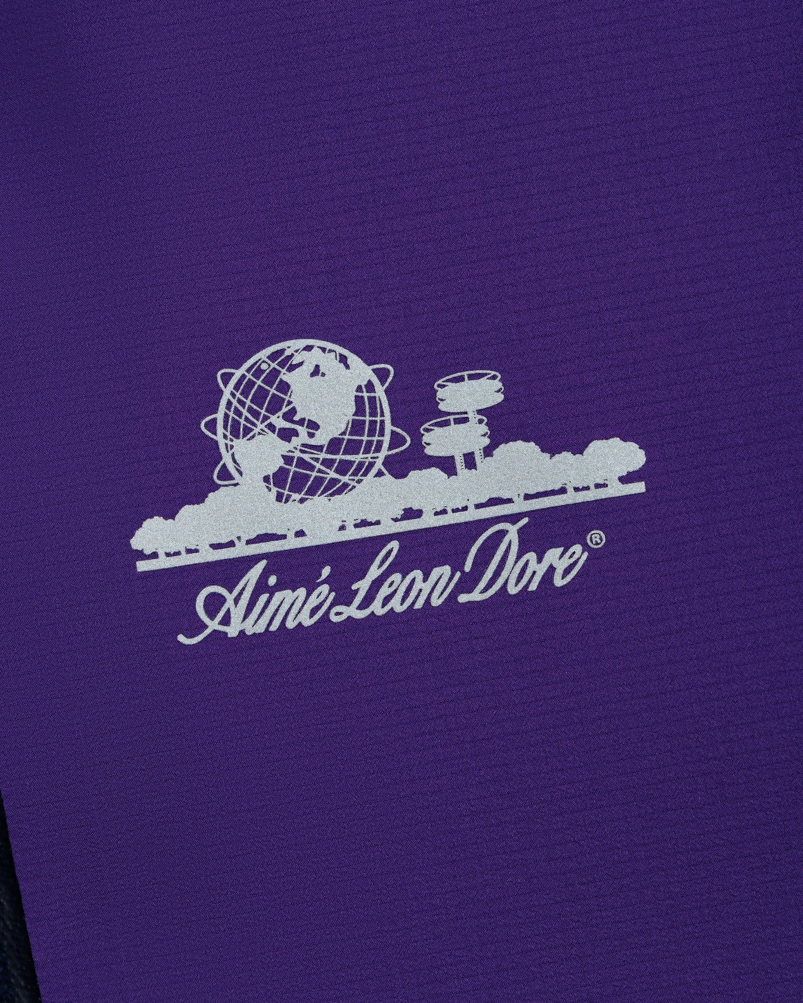White Aimé Leon Dore logo with globe and trees on purple Lightweight GORE-TEX Shell Jacket.