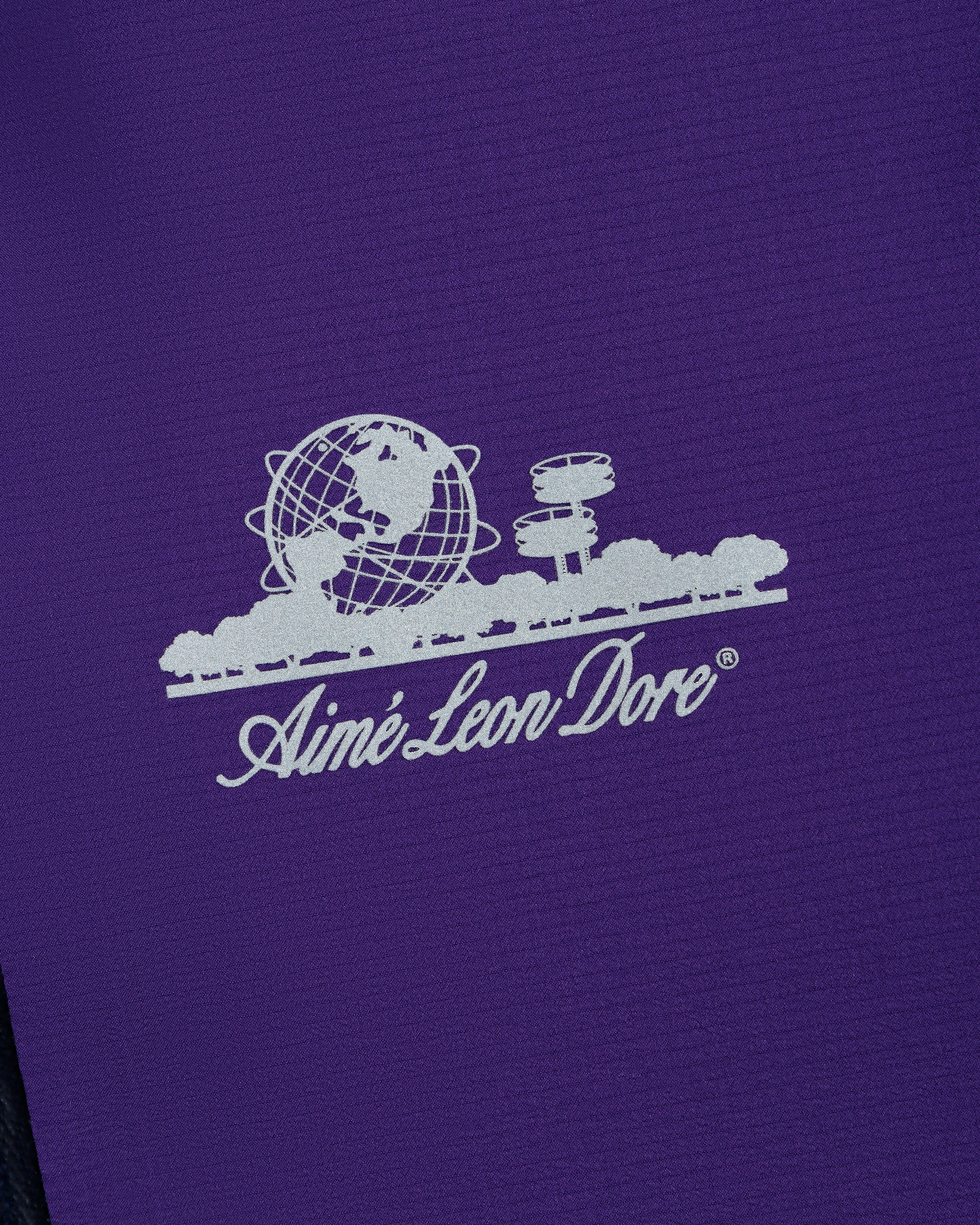 White Aimé Leon Dore logo with globe and trees on purple Lightweight GORE-TEX Shell Jacket.
