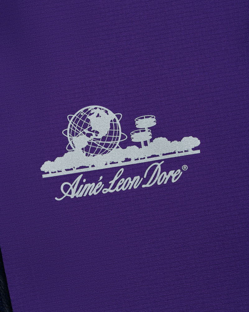 White Aimé Leon Dore logo with globe and trees on purple Lightweight GORE-TEX Shell Jacket.