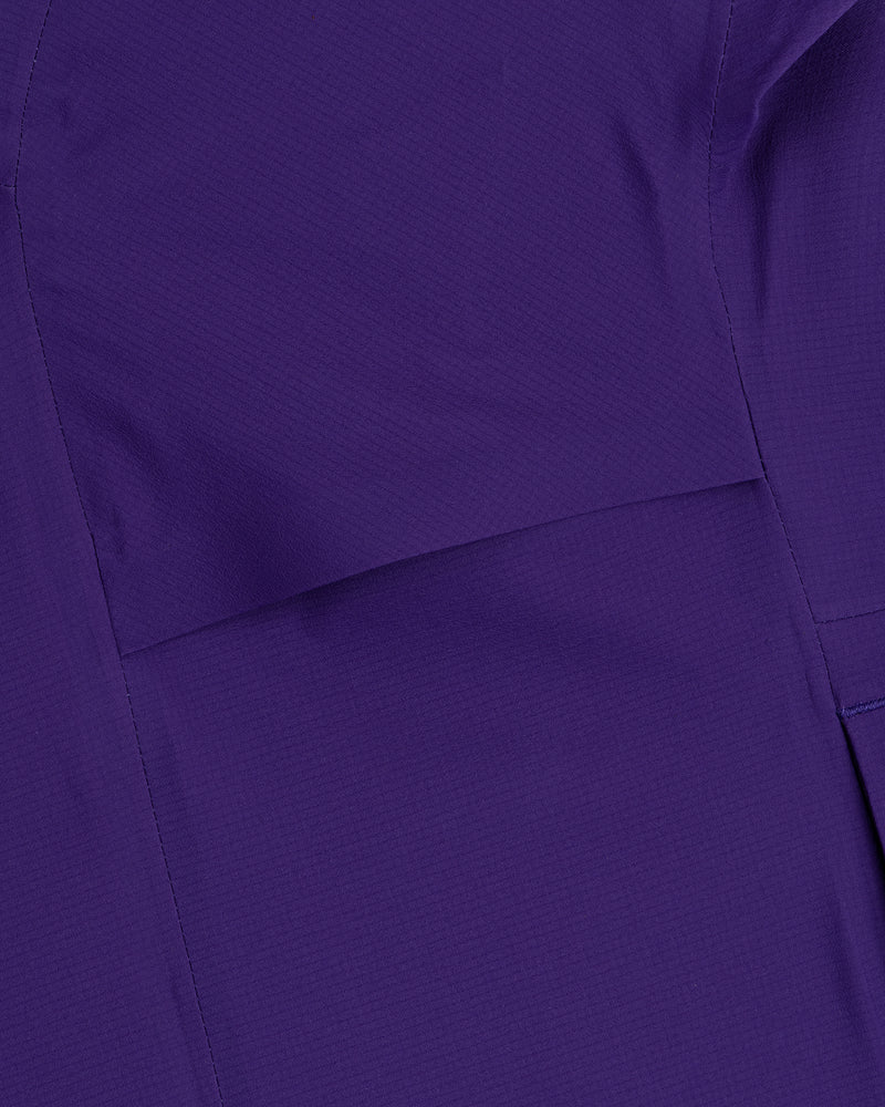 Close-up of purple GORE-TEX Shell Jacket fabric showing visible stitching and subtle texture.
