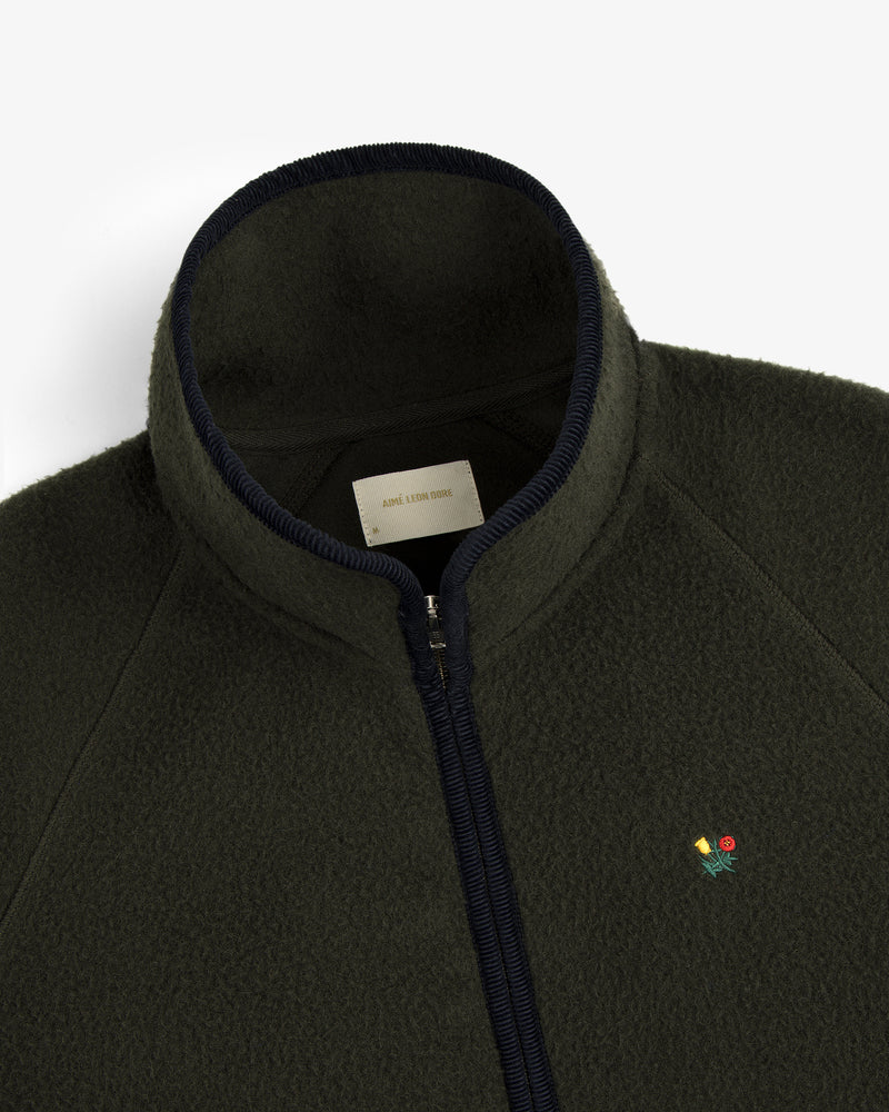 Casentino Crest Half-Zip Pullover in dark green with ribbed collar and small embroidered flower on the left chest.