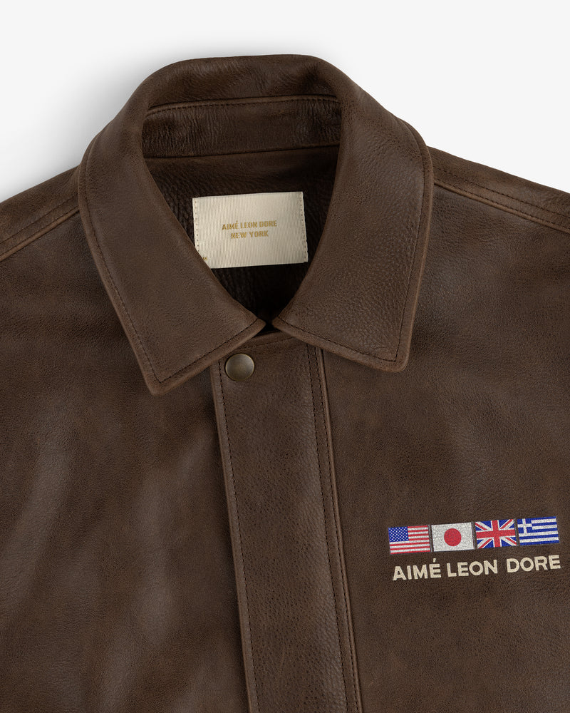 World's Borough Leather Flight Jacket with US, Japanese, UK & Greek flags and AIMÉ LEON DORE embroidered above chest pocket.