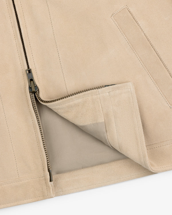 Close-up of a Leather Ranch Jacket in beige with a partially unzipped zipper and visible inner lining.