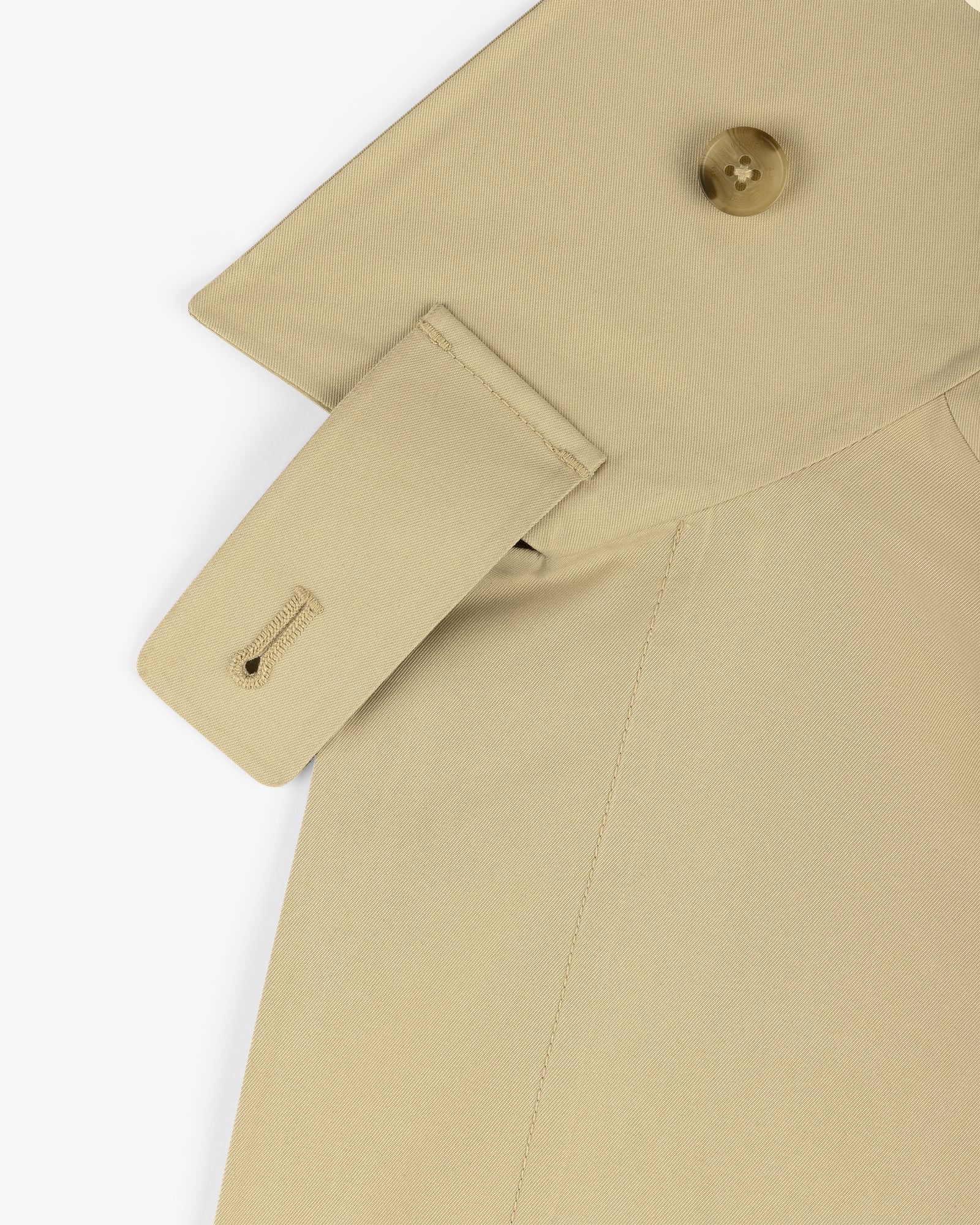 Close-up of GORE-TEX Balmacaan Coat shoulder with buttoned epaulette and visible stitching details.