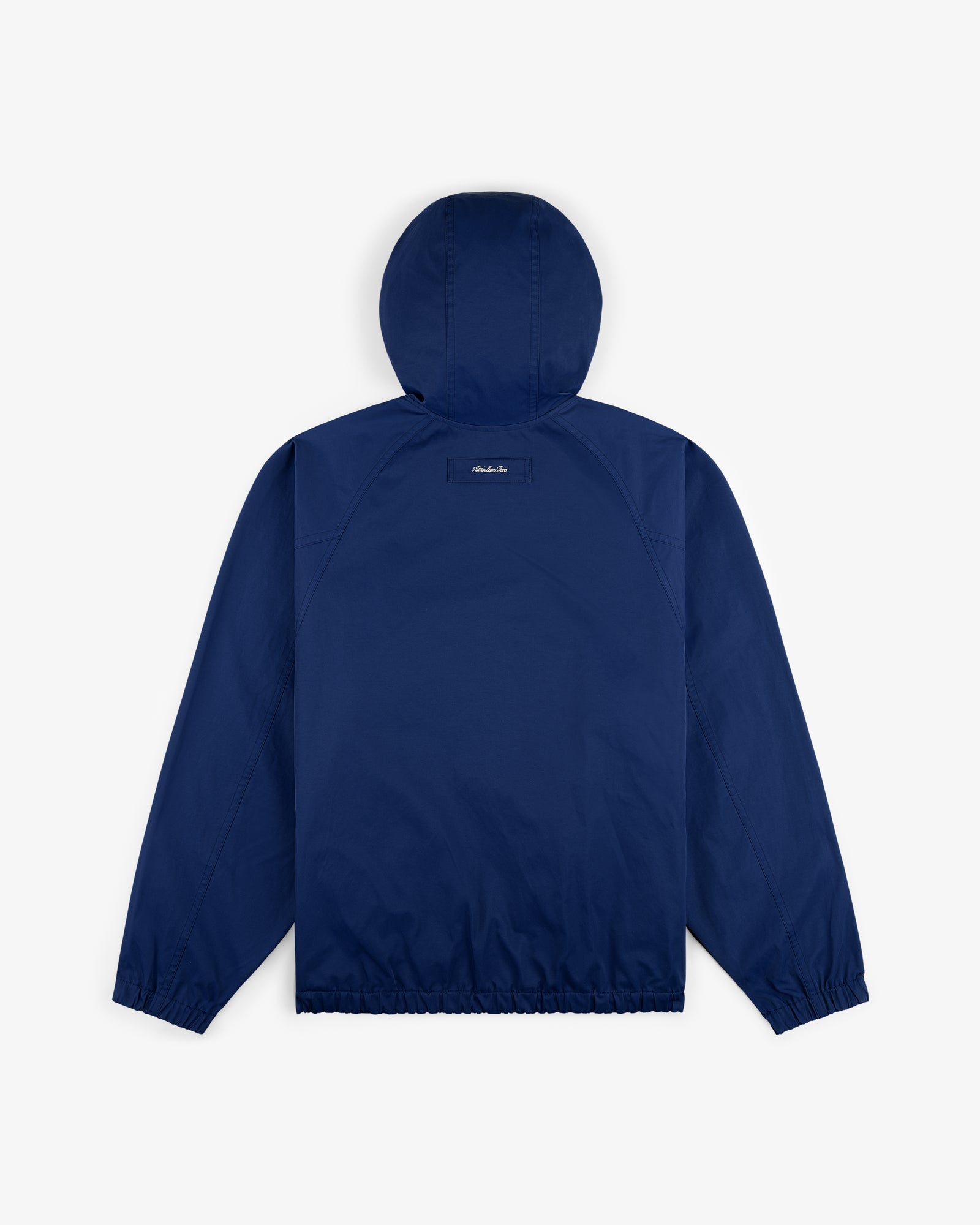Reversible Madras Windbreaker in navy blue, shown from the back with elastic cuffs and hem on a plain white background.
