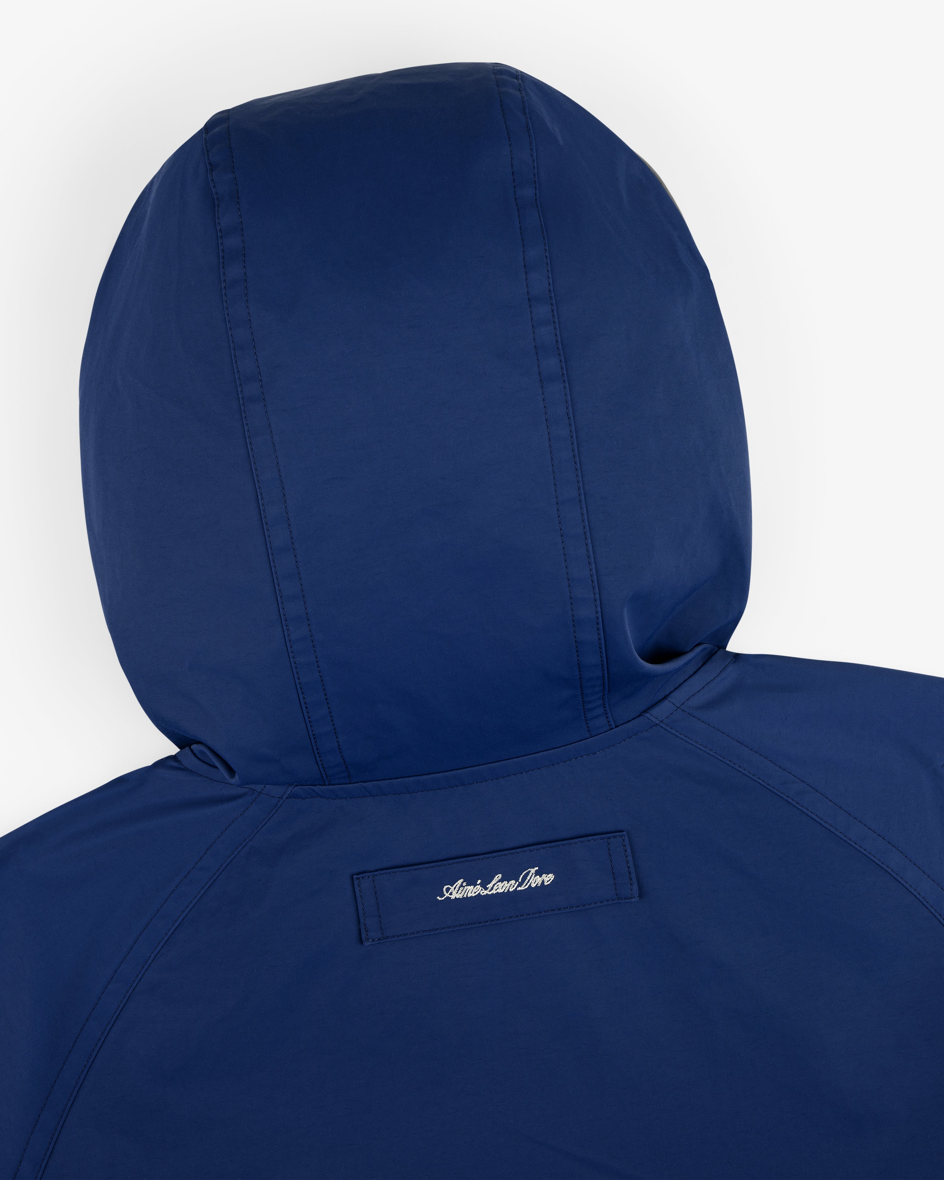 Reversible Madras Windbreaker with American River embroidered on a small patch below the back hood.