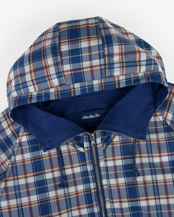 Reversible Madras Windbreaker in blue and white plaid with a zip front and solid blue hood lining.