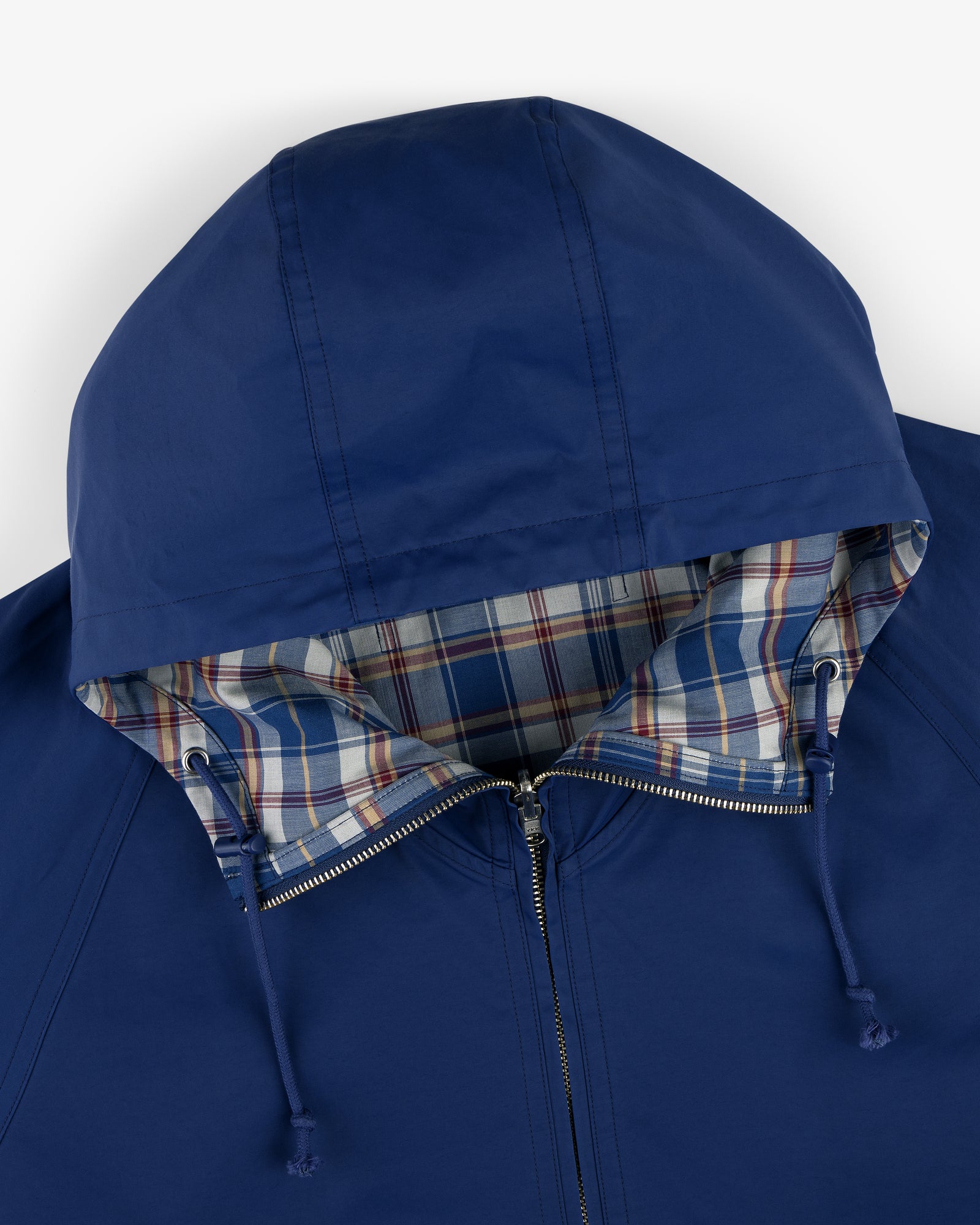 Reversible Madras Windbreaker: Blue zip-up hooded jacket with drawstring, plaid blue/red lining inside the hood.