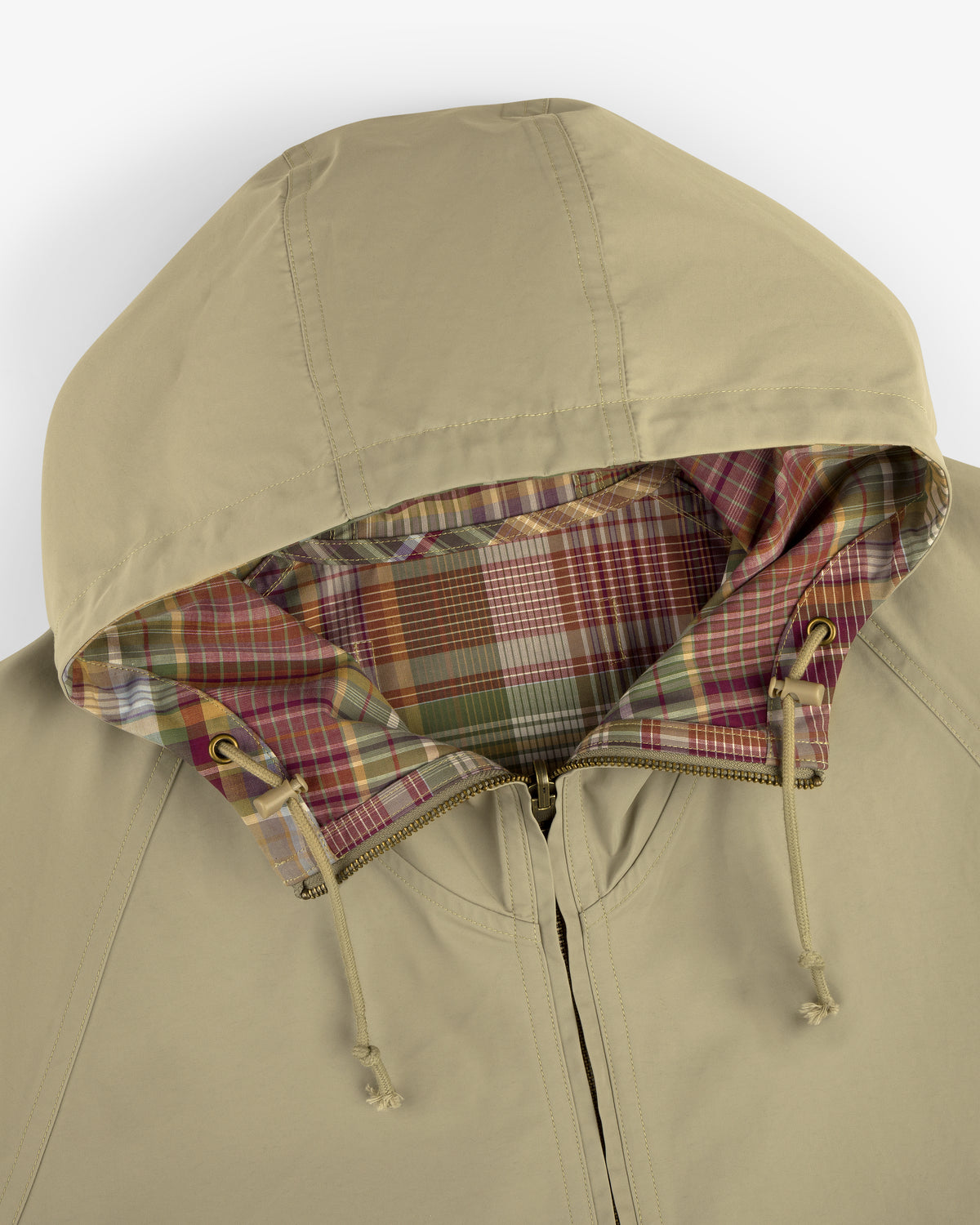 Reversible Madras Windbreaker in beige with plaid lining and drawstrings, shown from above.