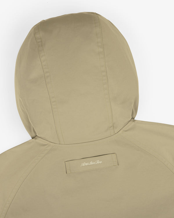 Reversible Madras Windbreaker in beige shown from the back, featuring visible stitching and a small label at the neckline.