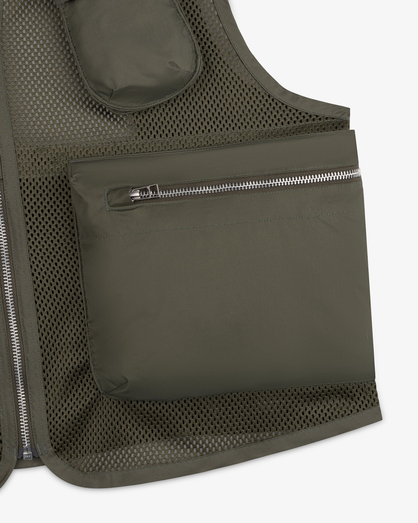 Close-up of the Nylon Utility Vest in olive green mesh, featuring a large zippered pocket and visible stitching.