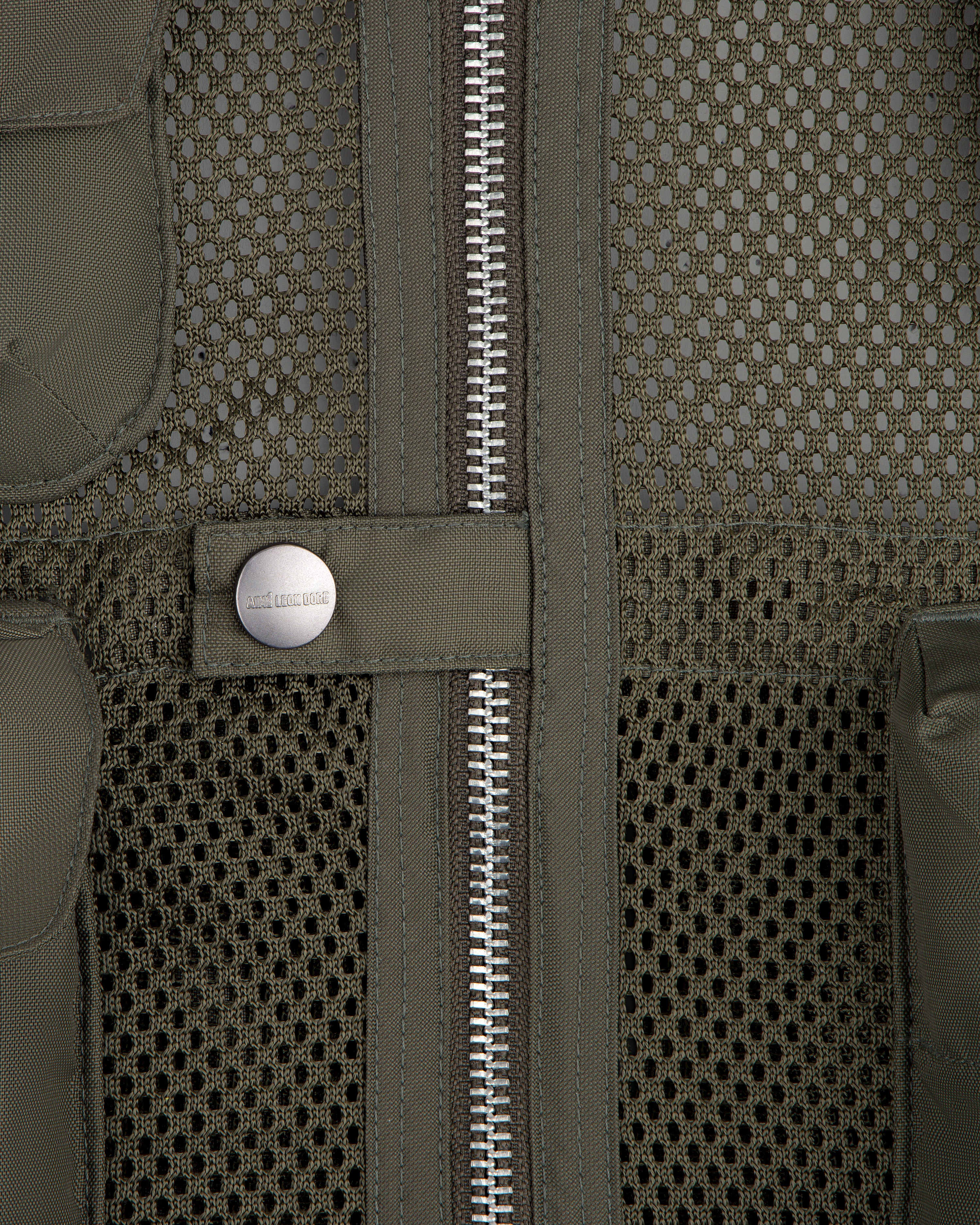 Close-up of the Nylon Utility Vest featuring mesh fabric, center zipper, snap button, and olive green color.