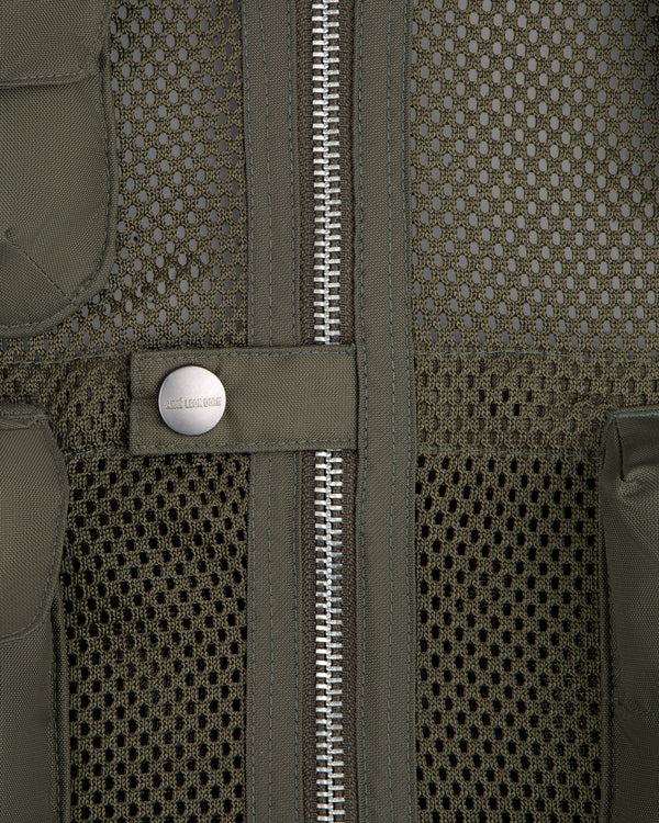 Close-up of the Nylon Utility Vest featuring mesh fabric, center zipper, snap button, and olive green color.