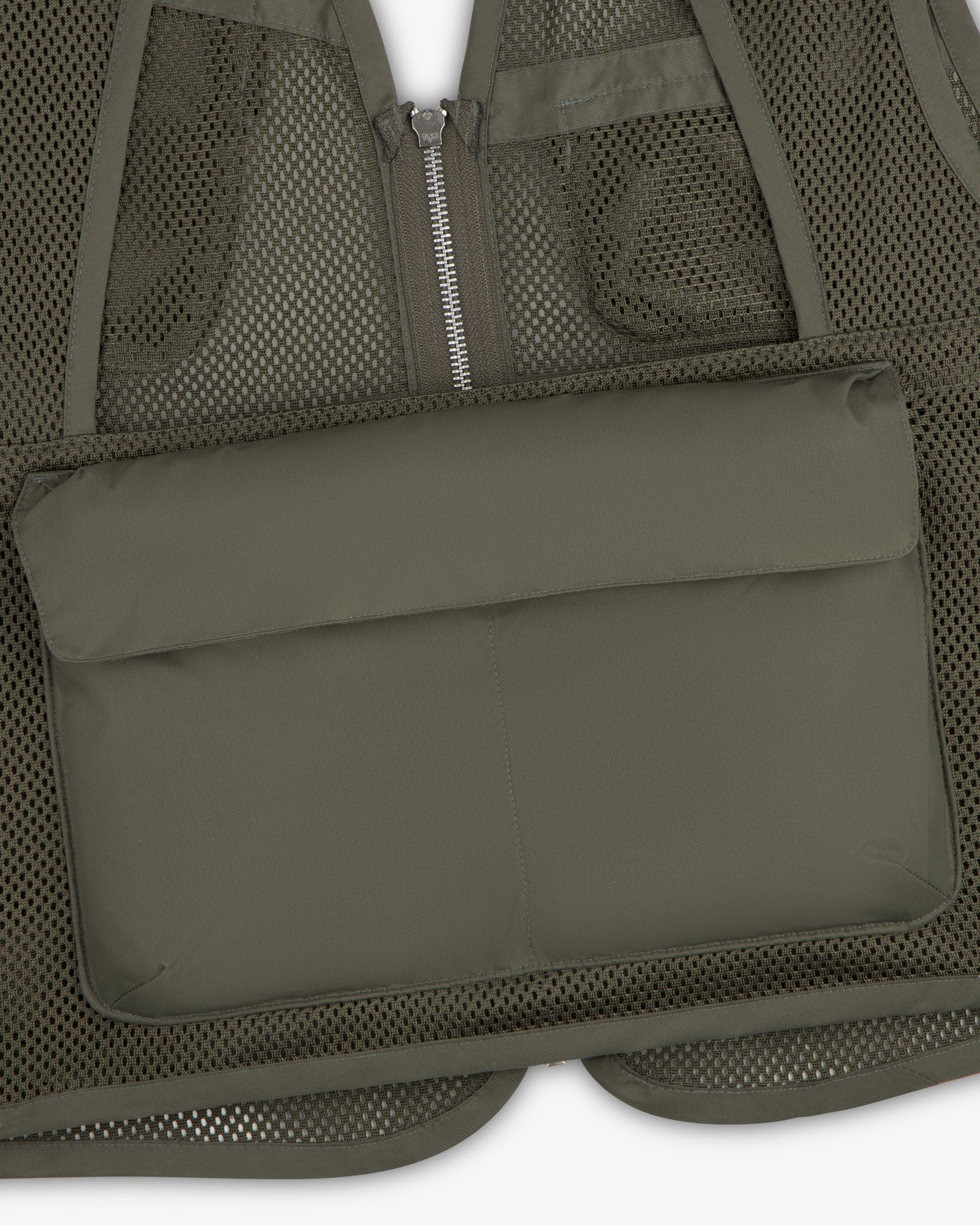 Close-up of the Nylon Utility Vest in olive green mesh with a zippered front and large padded pocket.