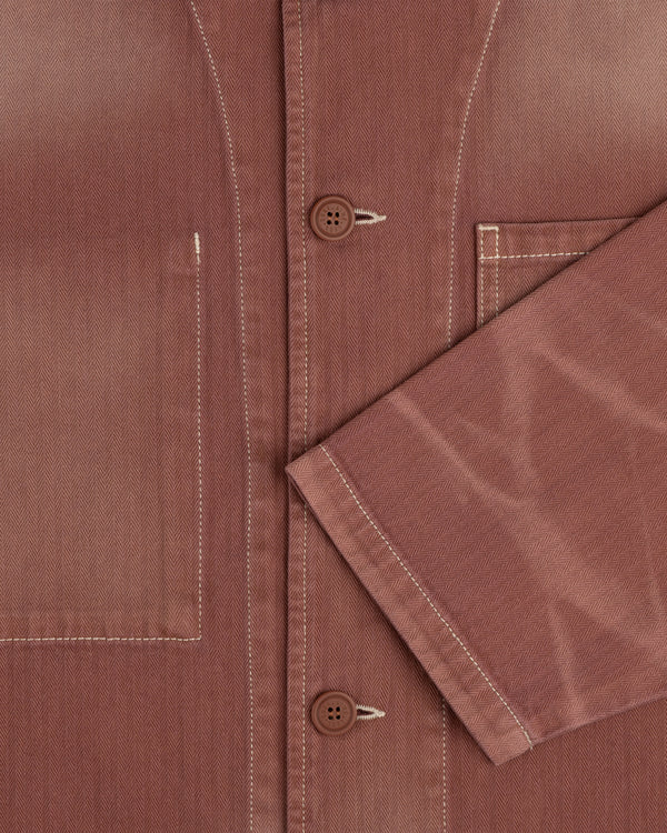 Close-up of the Sun Faded Chore Jacket showing white stitching, front pocket, and folded sleeve.