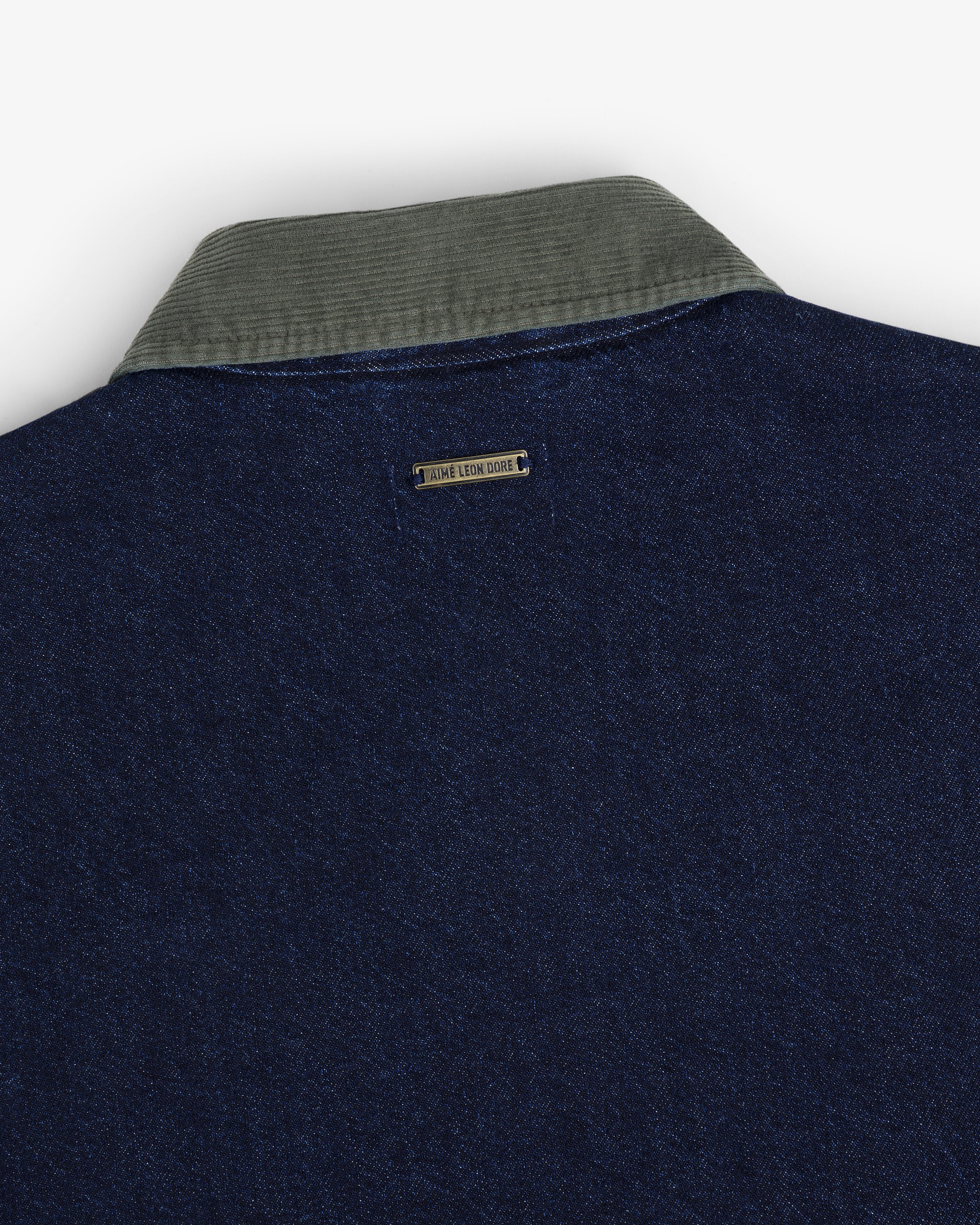 Close-up of the back of the Denim Zip Jacket with a gray corduroy collar and a small "TRUE LEAN CORE" tag.